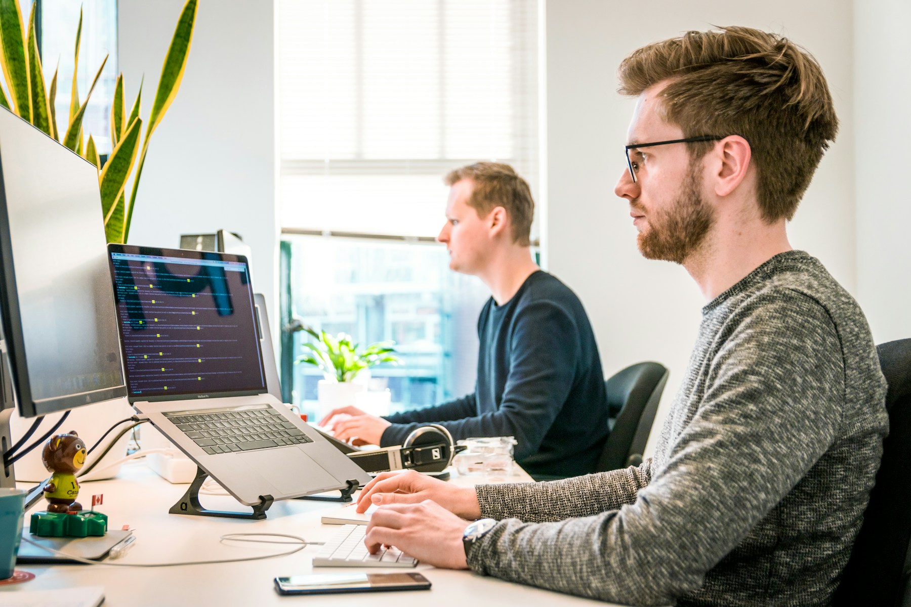 Product and growth operators in a startup setting reviewing metrics.